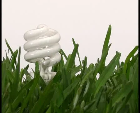 Energy saving light bulb in grass V3 - PAL Stock Footage 10761352