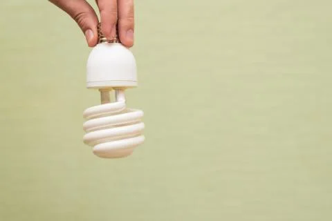 Energy saving light bulb in the hands of a man Stock Photos