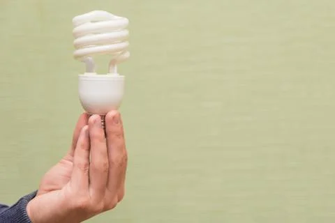 Energy saving light bulb in the hands of a man Fotos Stock