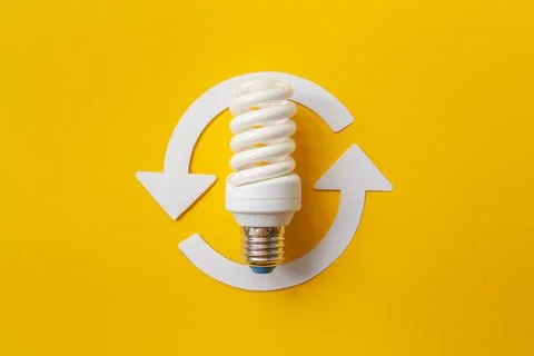 Energy saving light bulb on a orange background Stock Photos