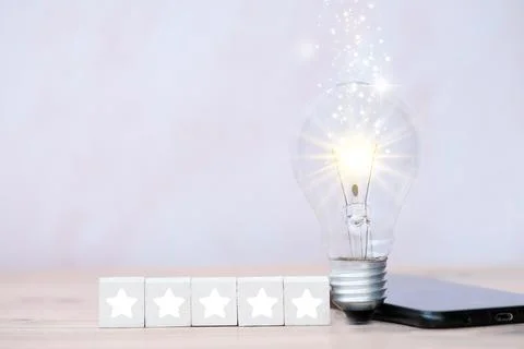 Energy saving light bulb on table and business growth concept and new ideas.. Stock Photos