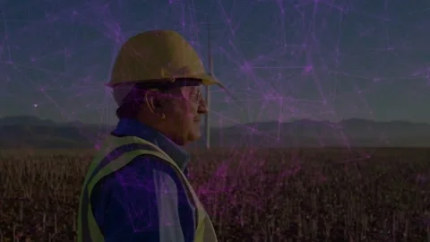 Energy tech in hard hat surveying turbine while camera shifting and purple web 스톡 동영상 334114396
