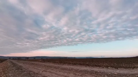 Enermous cloud with sharp edge timelapse over muddy road Stock Footage 145729125