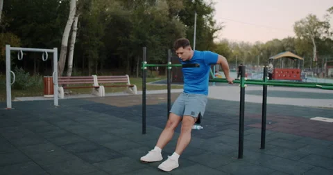 Engage in a Calisthenics Workout featuring Dips at your local Outdoor Park for Stock Footage 317977610