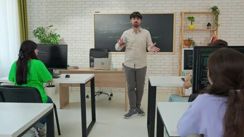 Engaged Computer Science Instructor Teaching in Modern Classroom Stock Footage 281071811