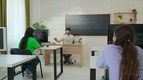 Engaged Computer Science Instructor Teaching in Modern Classroom Stock Footage 281071862