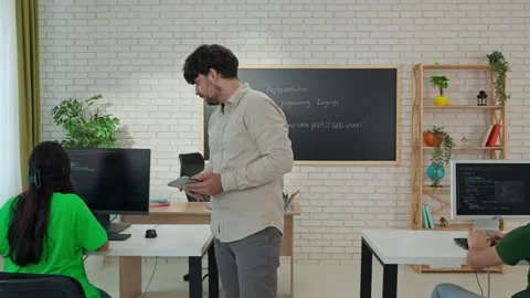 Engaged Computer Science Instructor Teaching in Modern Classroom Stock Footage 281071973