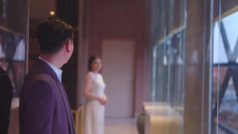 Engaged Couple Gazing at Each Other near Hotel Lobby Window Stock Footage 334037019