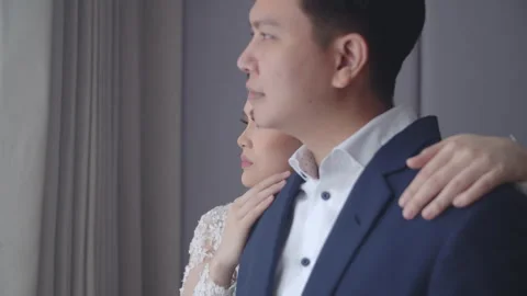 Engaged Couple Looking Out Hotel Window and Embracing Video stock 334026671