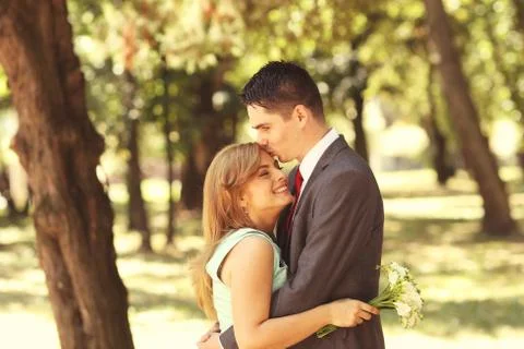 Engaged couple posing in the park Stock Photos