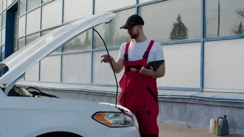 Engaged in deep diagnostics auto technician meticulously examined cars Video stock 272958534