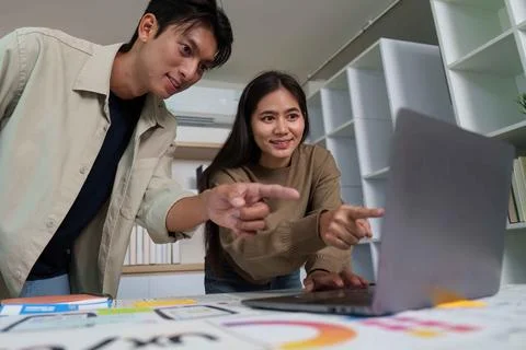Engaged Designers Analyzing UX UI Designs on Laptop Stock Photos