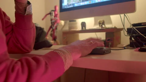 Engaged in focused programming using keyboard and terminal late night Stock Footage 322924708