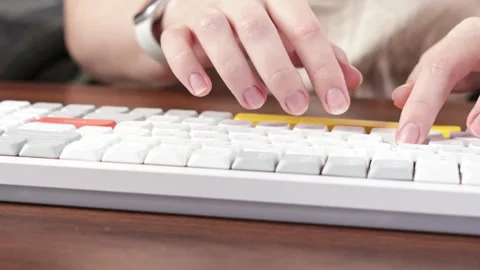 Engaged hands quickly typing on a contemporary white computer keyboard with.. Stock Footage 320463896