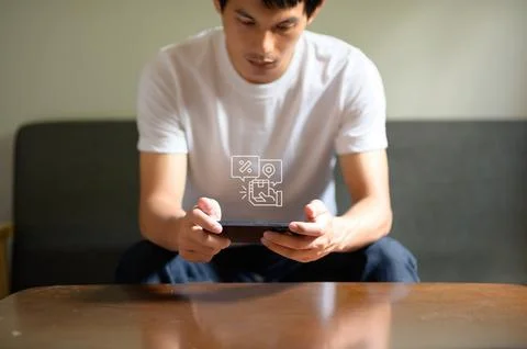 Engaged Man Using Smartphone for Online Shopping During Sale Event Stock Photos
