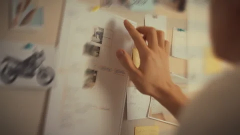 Engaged in organizing important information on a bulletin board for project Stock Footage 323764711