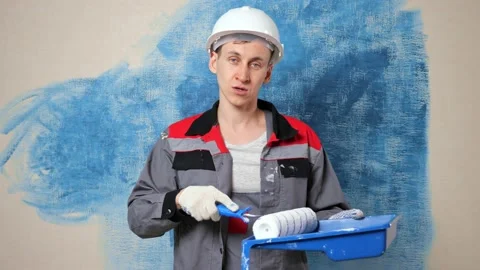 Engaged painter blogger in casque explains purpose of tray Stock Footage 154932915