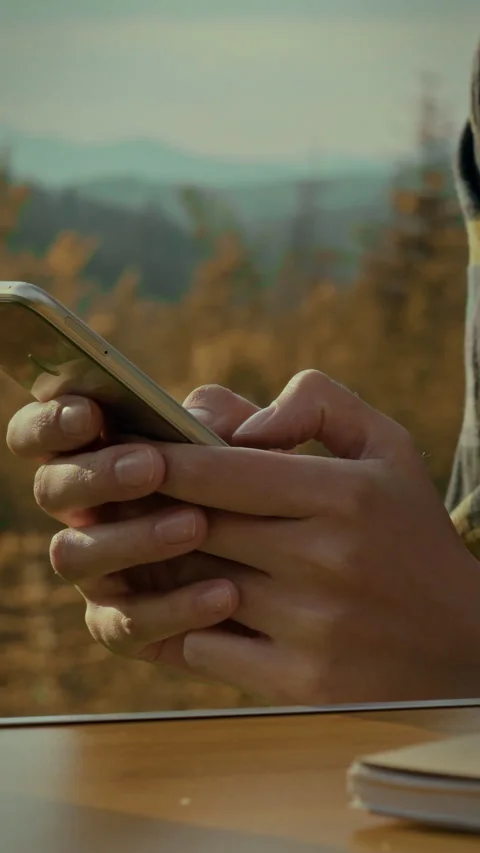 Engaged smartphone user enjoying nature views during a mountain trip Stock Footage 331569349