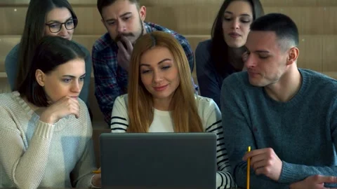 Engaged students collaborating over a laptop screen Stock Footage 311992489