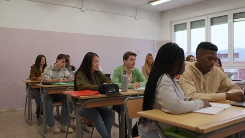 Engaged students learning attentively in bright classroom setting Stock Footage 301677397