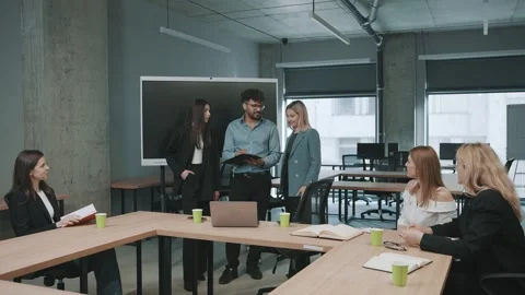 Engaged team collaborates in modern office space during productive meeting Stock Footage 312258709