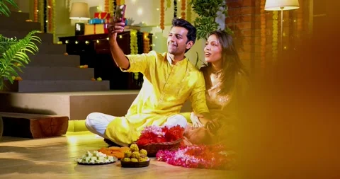 Engaged in video call celebration, Indian couple celebrating Diwali night Stock Footage 342381511