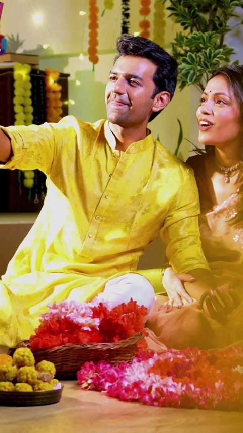 Engaged in video call celebration, Indian couple celebrating Diwali night Stock Footage 342382208