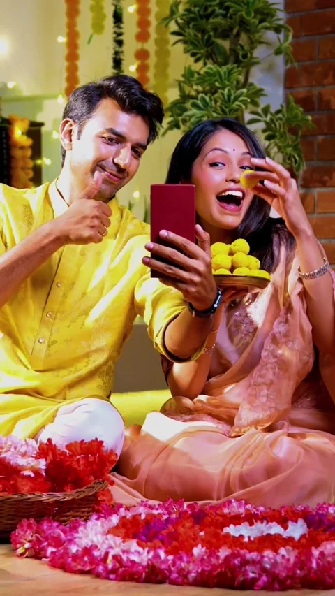 Engaged in video call celebration, Indian couple celebrating Diwali night Stock Footage 342382211