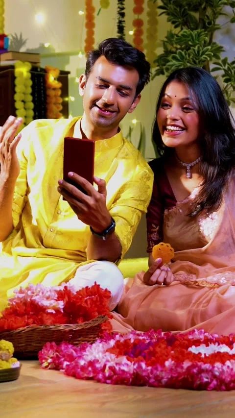 Engaged in video call celebration, Indian couple celebrating Diwali night Stock Footage 342382212