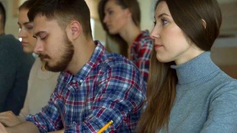 Engaged young students studying together in a vibrant college setting Stock-Footage 311986526