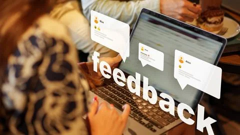 Engagement with feedback through a laptop at a cafe setting during the day Stock Photos
