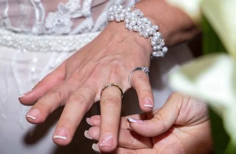 The engagement ring on the bride's hand Stock Photos