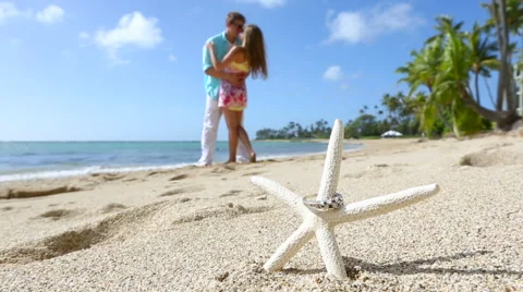 Engagement ring on the starfish beach love concept Stock Footage 58172931