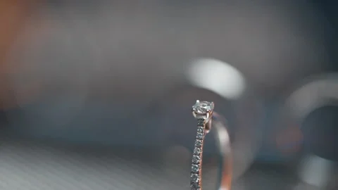 Engagement Ring With Wedding Rings In Background Are Spinning. Close Up Macro Stock Footage 198347431