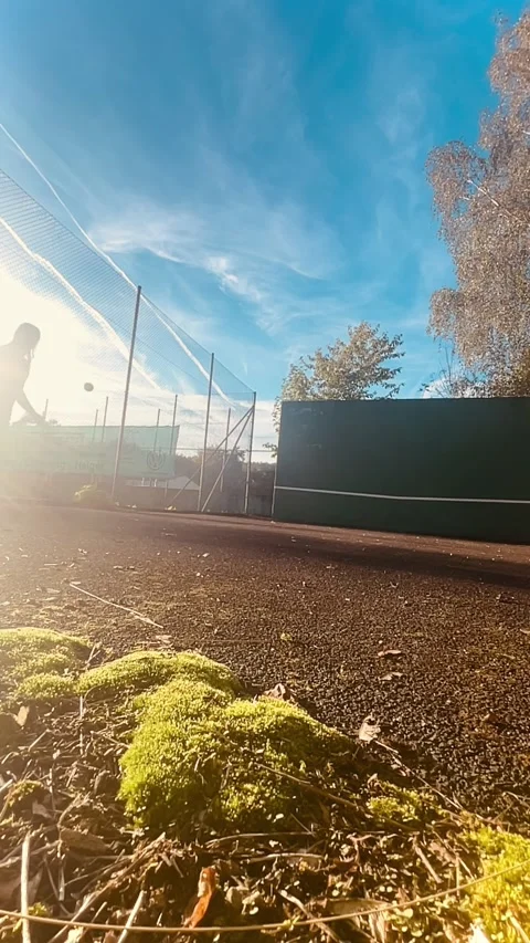 Engaging and Dynamic Tennis Practice Session Happening Under the Clear Blue Sky Stock Footage 315435064