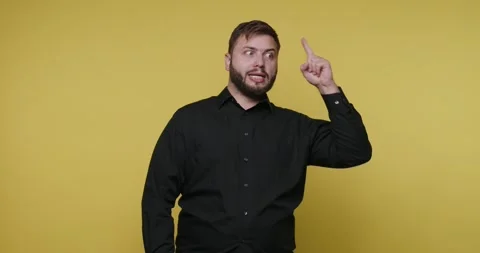 Engaging and insightful gestures in a bright yellow backdrop with expressiv.. 動画素材 329110964