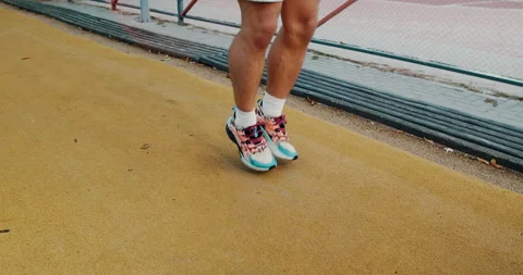 Engaging in an Athletic Jumping Workout on a Track to enhance performance and Stock Footage 317836592