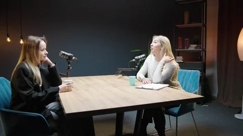 Engaging business discussion between two women in a podcast studio Stock Footage 304422351