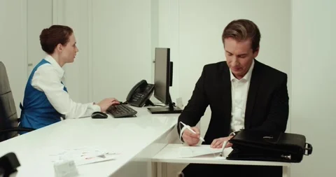 Engaging in Business Interactions at the Reception Desk in a Modern Office Space Stock Footage 282456262