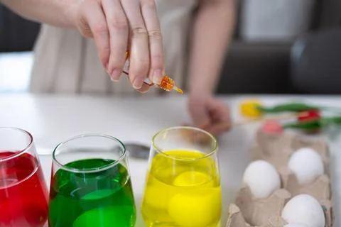 Engaging in Colorful Egg Dyeing Activity for Fun Springtime Celebrations wi.. Stock Photos
