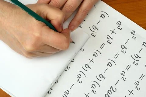 Engaging in complex equations while studying mathematics at a desk Stock Photos