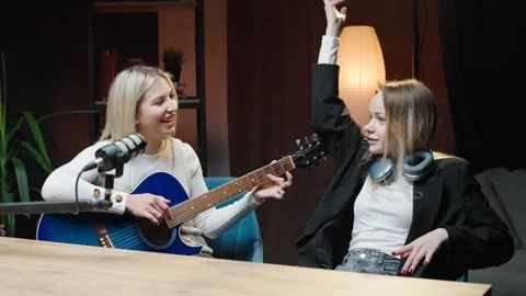 Engaging conversation and music exploration in a dynamic podcast studio setting Stock Footage 315909226