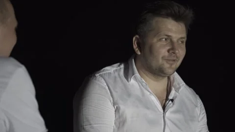 Engaging conversation between two individuals in a dimly lit setting, showcasing Видео 347869657