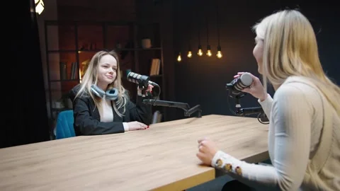 Engaging conversation between two women in a business podcast studio setting Video stock 315909410