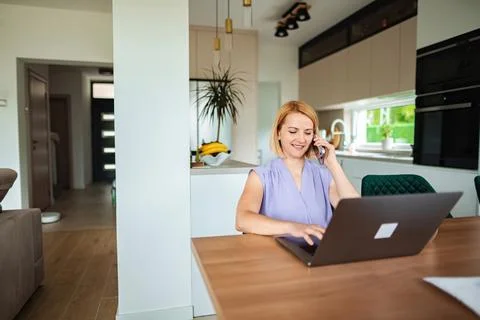 Engaging conversation while multitasking at home office Stock Photos