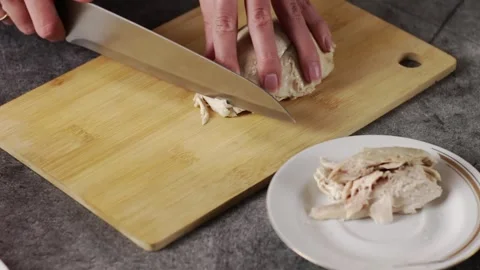 Engaging in the Cooking Preparation Process with Fresh Chicken on the Cutting Stock Footage 303374051