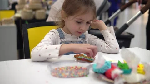 Engaging in Creative Cookie Decoration Fun with an Array of Colorful Video stock 280410072