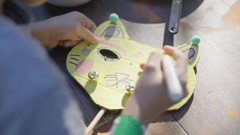 Engaging in Creative Crafting A Fun Project Creating a Colorful Cat Mask for Stock Footage 306413145