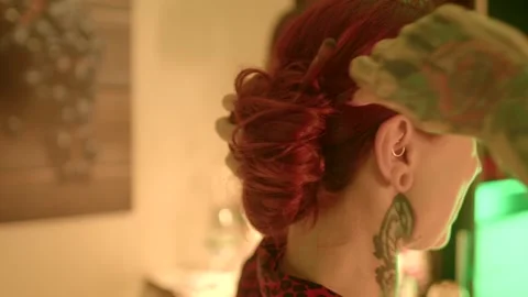 Engaging in Creative Hair Styling Techniques Featuring Striking and Vibrant Red  Stock Footage 291932258