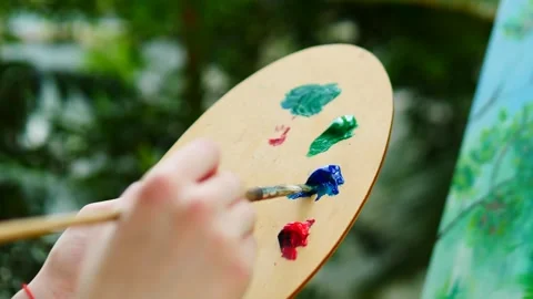 Engaging in a Creative Painting Process with Your Palette while Surrounded by Stock Footage 311909826